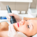 Woman getting skin resurfacing treatment