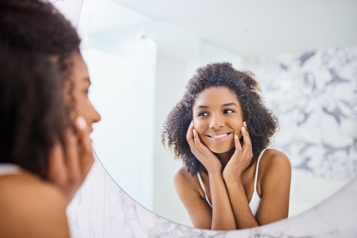 Woman doing her skincare in mirror